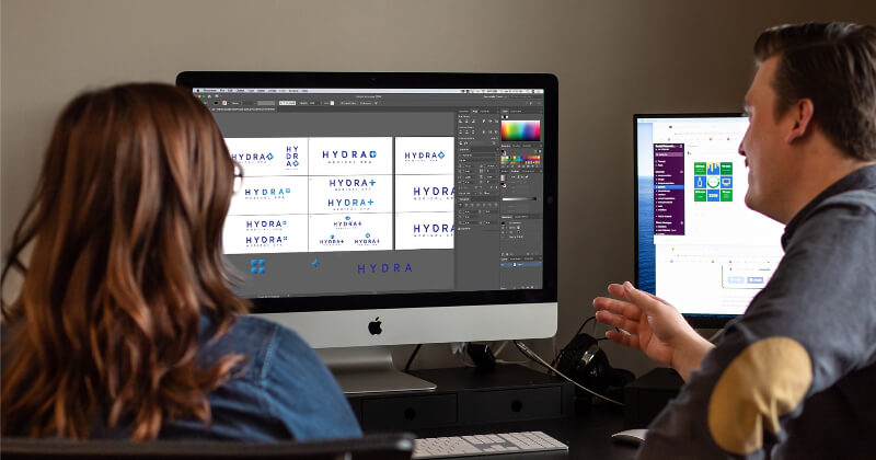 Two SNMD designers working on a logo project