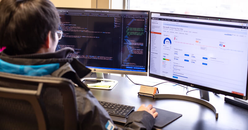 A web developer siting at a desk and working