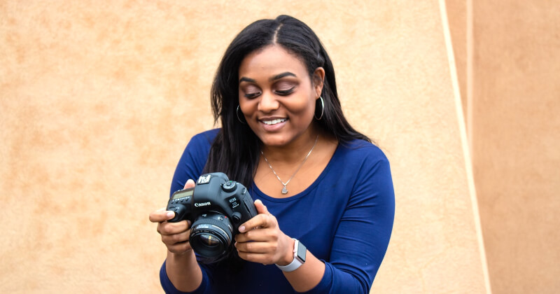 An SNMD employee using a camera