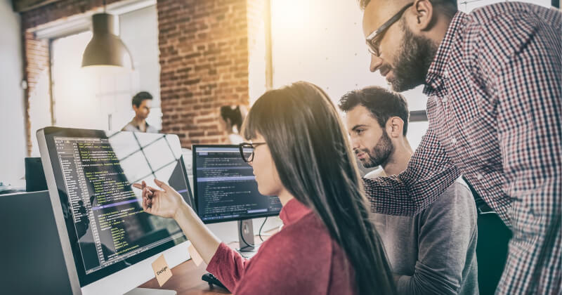 A team in the office working on a computer