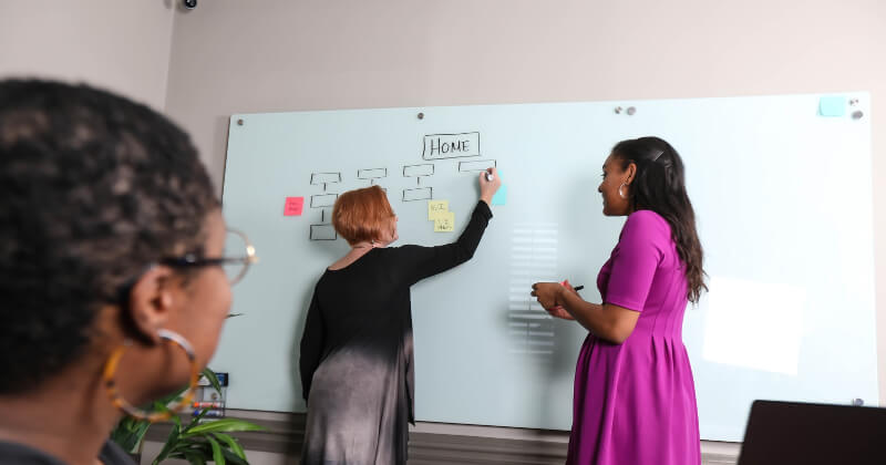 SNMD employees working on a website wireframe